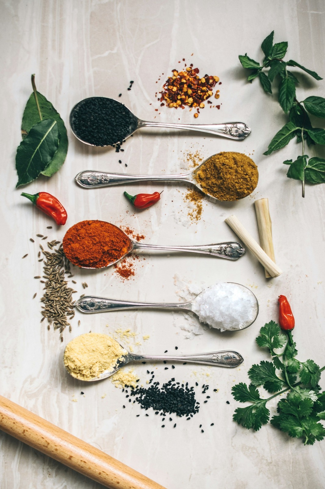 Measured spices on spoons, ready for cooking